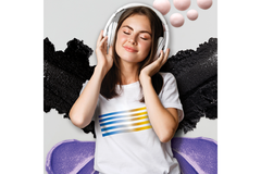 Image A dark haired woman closes her eyes and smiles while wearing headphones.